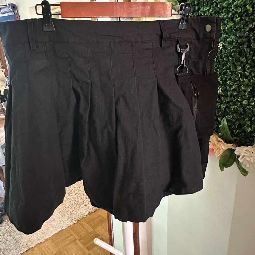 Black pleated mini-skirt with chain and pocket detail